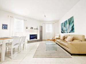 a living room with a couch and a table at Hilltop Retreat in Kalkara