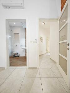 a white hallway with a door and a bathroom at Hilltop Retreat in Kalkara +20 photos