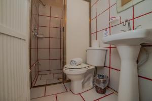 a bathroom with a toilet and a shower and a sink at Hotel Sol Caribe in Isla Mujeres +37 photos