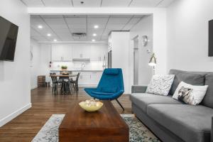 a living room with a couch and a table at Spacious 1 Bed with Mountain Views only steps from Downtown in Canmore