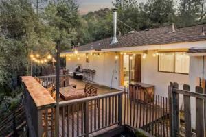 a porch of a house with a deck with lights at Phoenix Lake Sonora in Sonora