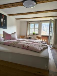 a bedroom with a large bed and a window at Hansenchristenhof in Gutach +35 photos