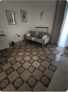 a living room with a couch and a tile floor at IN CENTRO apartments in Torre Maggiore