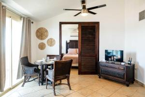 a living room with a dining table and a bedroom at Villa Costera 904 | Island Escapade | Culebra in Culebra +46 photos