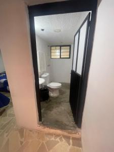 a doorway to a bathroom with a toilet in it at Departamento MG in Puebla
