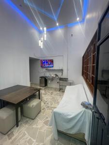 a dining room with a table and a tv on the wall at Departamento MG in Puebla