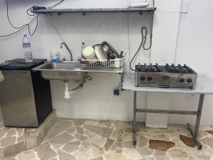 a kitchen counter with a sink and a sink at Departamento MG in Puebla