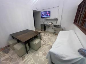 a living room with a table and a tv on a wall at Departamento MG in Puebla +15 photos