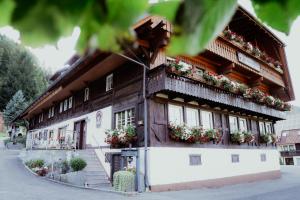 a wooden building with flower boxes on the windows at Hansenchristenhof in Gutach