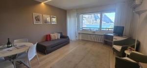 a living room with a couch and a table at Bianca Apartment in Bissone