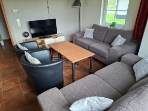 a living room with a couch and a table at Haus am Golfplatz Cochem Mosel in Ediger-Eller