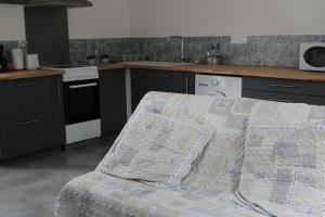 a kitchen with a bed in the middle of it at Maison de Gilydie in Chabris