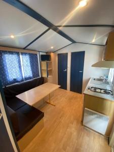 a small kitchen with a table and a stove at Camping Playa de Ris in Noja