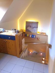 an attic room with a sink and a staircase at Kleine FeWo, Einstiegspreis! in Weimar