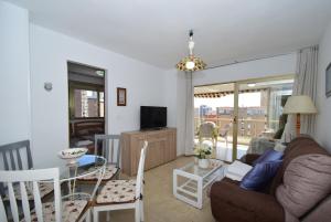 a living room with a couch and a table at ADELFAS - Fincas Arena in Benidorm