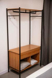 a closet with a wooden shelf and a wooden table at Urban Studio in Blumenau