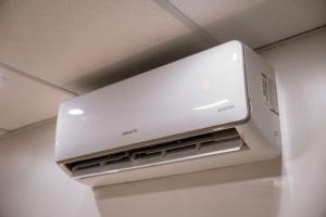 a white microwave oven sitting on top of a refrigerator at Urban Studio in Blumenau +19 photos