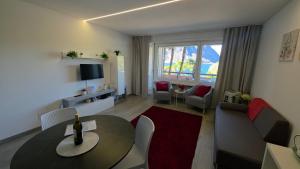 a living room with a table and a couch at Adele's Apartment in Bissone