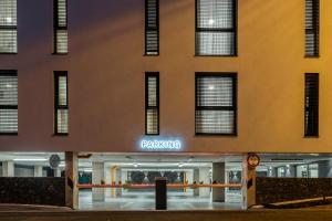 a building with a parking sign in front of it at Hotel Tříška in Brandýs nad Labem