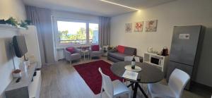 a living room with a couch and a table at Adele's Apartment in Bissone