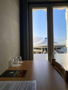 a table with a view of an airport at Hotel Le Terminus in Mons