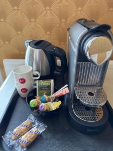 a coffee maker with a plate of food and a cup of coffee at B&B Pastorie Jelsum in Jelsum