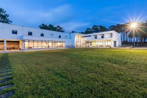 a white building with a field in front of it at HI Ovar - Pousada de Juventude in Ovar