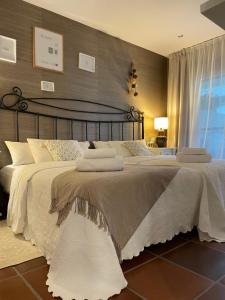 a bedroom with a large bed with white sheets at Beautiful Marbella Apartment in Marbella