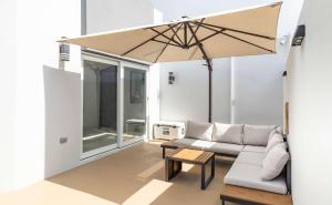 a living room with a couch and an umbrella at AQUA Casa A-8 - Vibrant & FUN 3 BR House with Pool in Dorado +28 photos