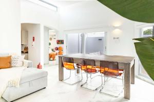 a living room with a wooden table and chairs at AQUA Casa A-8 - Vibrant & FUN 3 BR House with Pool in Dorado