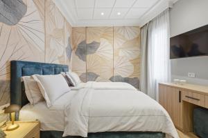 a bedroom with a bed and a wall mural at Hotel Giulia in Durrës