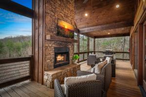a living room with a stone fireplace on a deck at 249 Ranger Station in Morganton