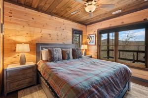 a bedroom with a bed in a log cabin at 249 Ranger Station in Morganton