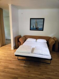 a bed in a room with a white bedvisor at Lägenhet Bolum 7 in Broddetorp