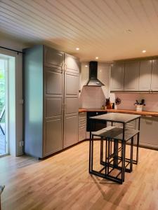 a kitchen with a table in the middle of a room at Lägenhet Bolum 7 in Broddetorp