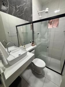 a bathroom with a sink and a toilet and a shower at Residencial Junino do Mestre - Casa 66 in Caruaru +17 photos