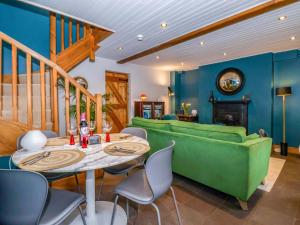 a living room with a table and a green couch at The Green in Ripon