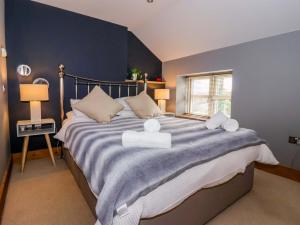 a bedroom with a large bed with two towels on it at The Green in Ripon
