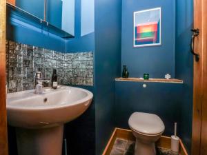 a blue bathroom with a sink and a toilet at The Green in Ripon +21 photos