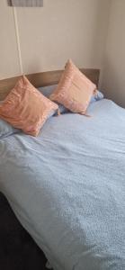 two pillows sitting on top of a bed at 128 Lido Beach in Prestatyn