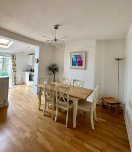 a dining room with a table and chairs at Central Taunton Townhouse in Taunton
