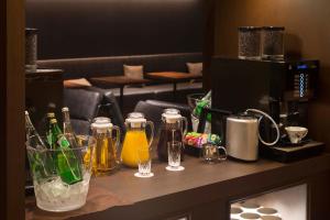 a counter with bottles of beer and glasses on it at Royal Park Hotel Takamatsu in Takamatsu