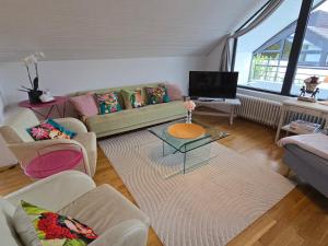 a living room with a couch and a table at Fewo Lieblingsblick, gemütlich & chic in Bad Münstereifel