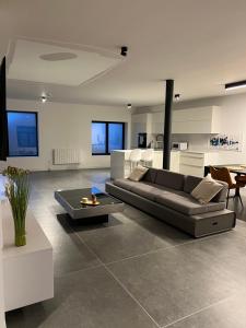 a living room with a couch and a table at L'Arsenal Loft in Couvin