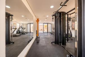 a gym with treadmills and machines in a room at Flats Osasco Trade Center in Osasco