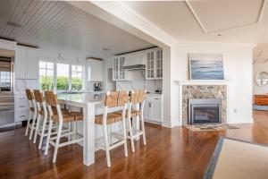 a kitchen with a table and chairs and a fireplace at Mother`s Beach House in Kennebunk