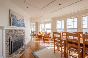 a living room with a fireplace and a table and chairs at Mother`s Beach House in Kennebunk