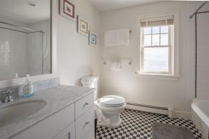 a white bathroom with a toilet and a sink at Mother`s Beach House in Kennebunk +35 photos