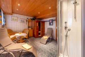 a bathroom with a shower and a table and chairs at Bauernhof Klausbauer in Grossarl +64 photos