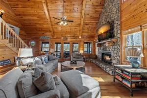 a living room with couches and a stone fireplace at Johnny's Lakeside Hideaway in Morganton